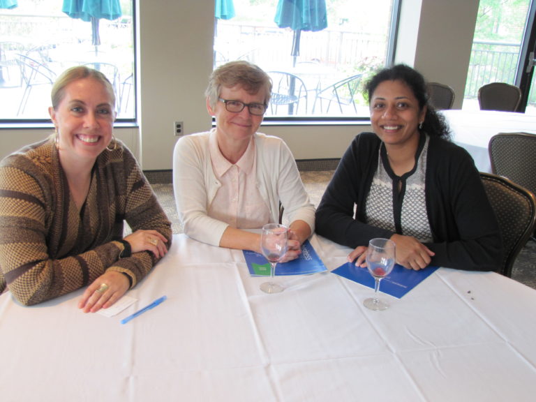 Three people sat at a table